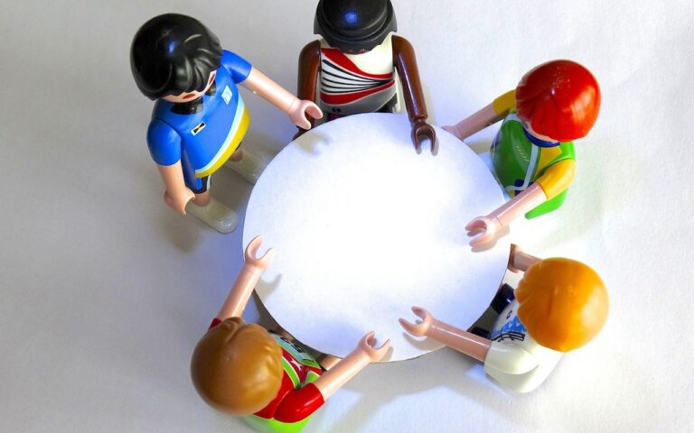Toy figures sitting around a circular table